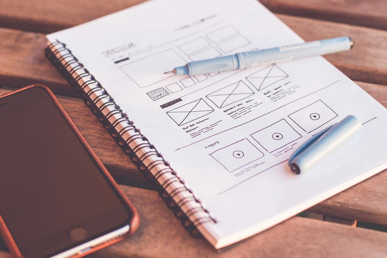 Designer sketching wireframes and UI layouts