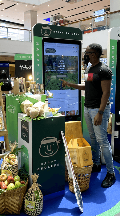 Person at Happy Grocers kiosk booth
